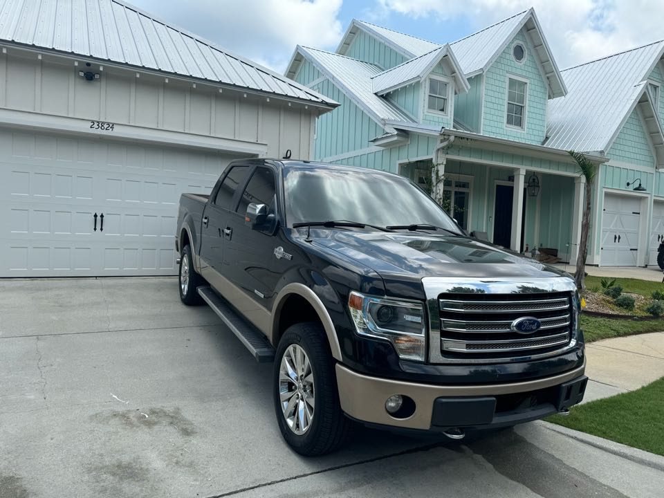 Black Ford F-150 detailed in a Gulf Coast driveway