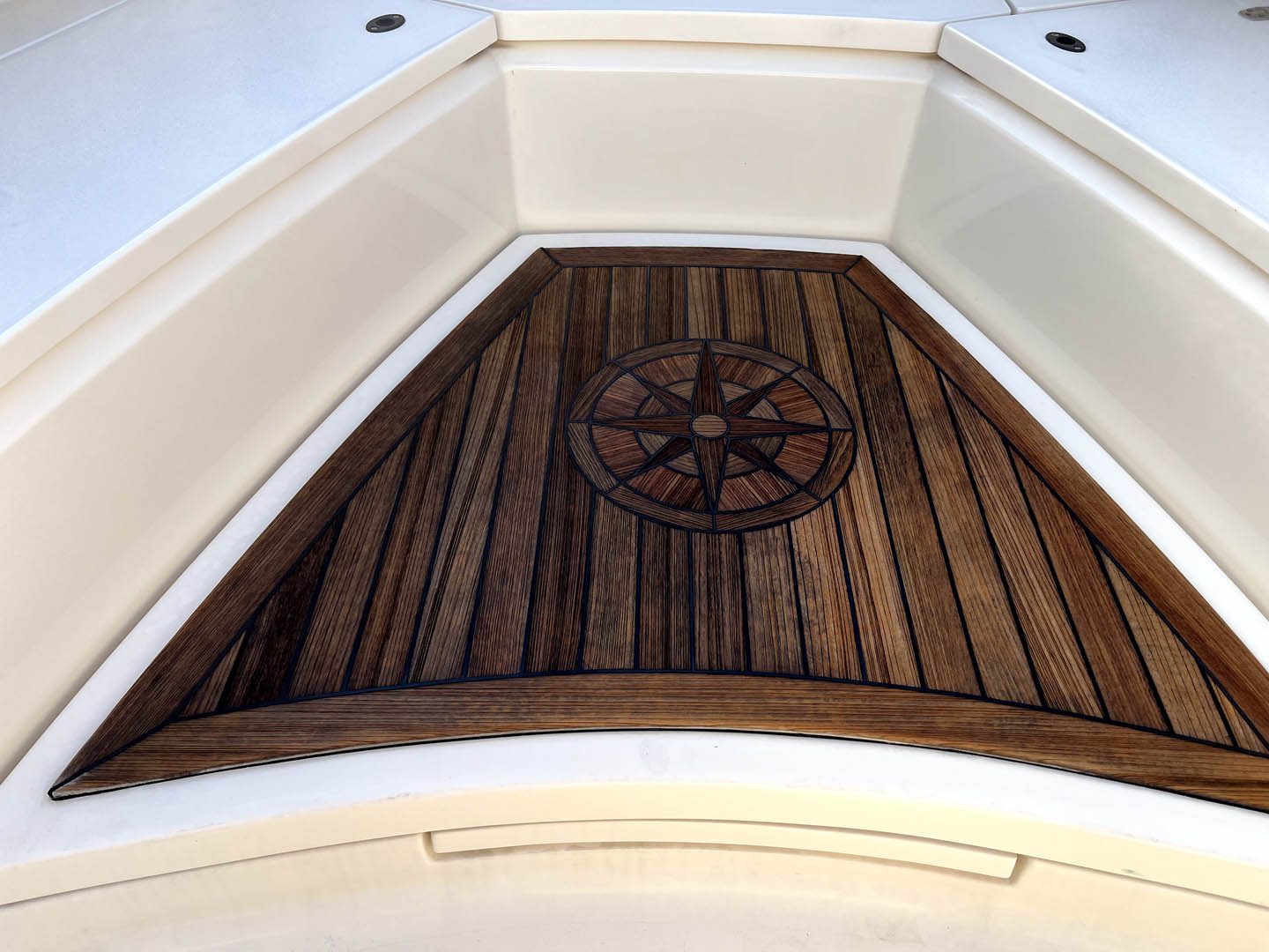 Restored teak bow deck with compass inlay