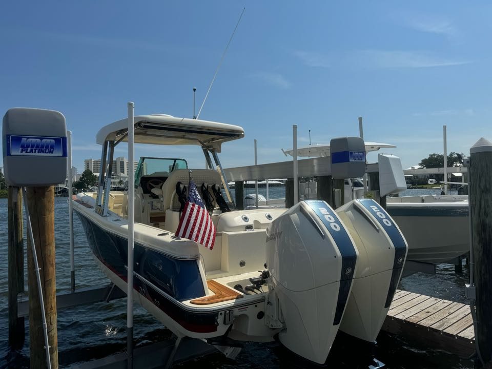 Twin-outboard boat detailed at a private dock