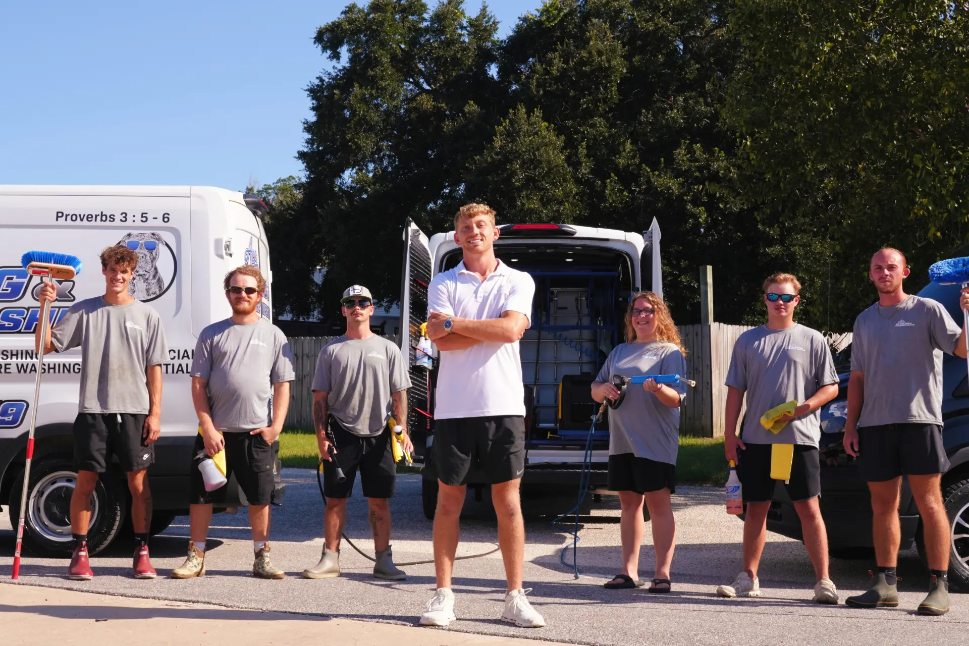 The Ace Mobile Detailing crew standing in front of their service vans